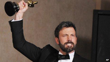 Ben Affleck poses with his award for best picture for Argo