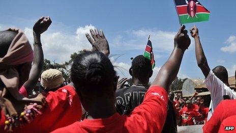Youths participate in demonstration, waving Kenyan flags in the air