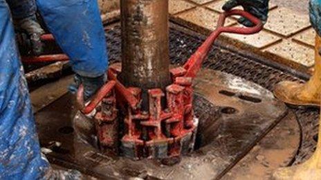 Engineers work on drilling platform at fracking facility