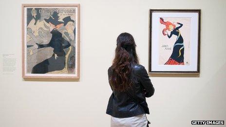 Visitor looks at works by Henri de Toulouse-Lautrec at the Courtauld gallery in London