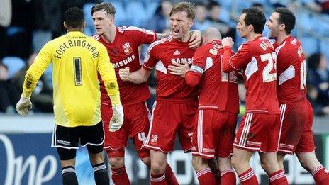 Swindon celebrate Darren Ward's last-minute winner at the Ricoh Arena