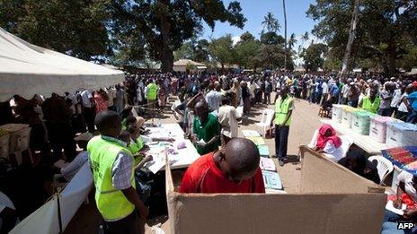 A man casts his vote as people queue ready to vote in the Mshomoroni area of the coastal city of Mombasa on 4 March 2013 during the nationwide election