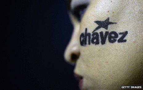 Mourner with Chavez written on her cheek