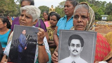 Sri Lankan Tamil women hold up photographs of their missing sons during a protest against the Sri Lankan government in Colombo on Wednesday (6 March 2013)