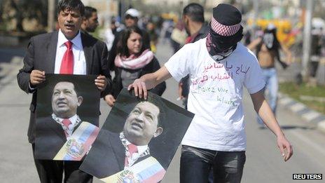Palestinian demonstrators hold posters depicting of late president Hugo Chavez during a protest outside Israel's Ofer military prison near the West Bank city of Ramallah, in support of hunger striking Palestinian detainees held in Israeli jails