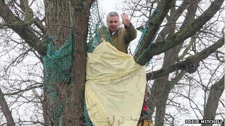 Protester in tree