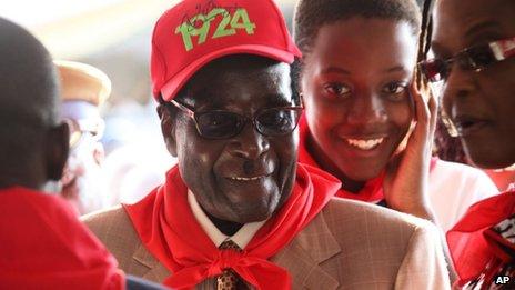 Zimbabwean President Robert Mugabe during celebrations to mark his 89th birthday in Bindura on 2 March 2013 - wearing a R G Mugabe label cap with the year 1924 printed on it - the year of his birth