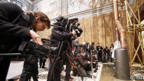 Media films the stove at the Sistine Chapel in the Vatican March 9