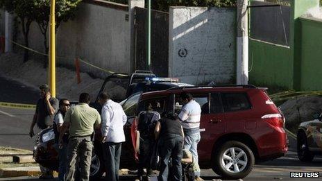 Investigators at the scene of the killing of Jalisco state's tourism minister