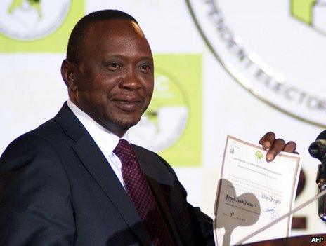 Uhuru Kenyatta shows a certificate confirming him as Kenya's new president in Nairobi, 9 March