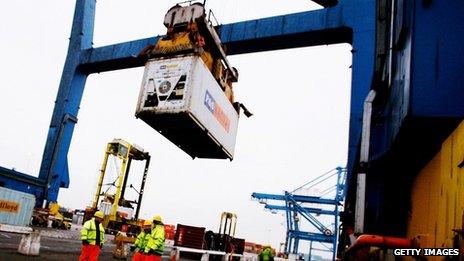 Ship freight containers are unloaded at the Tilbury Docks in Essex