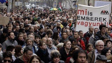 Hungarian NGOs hold up a banner (constitution democracy rule of law) as they protest at changes to the new constitution in Budapest on March 9, 2013.