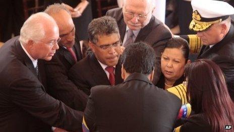 Venezuelan ministers around Hugo Chavez's coffin