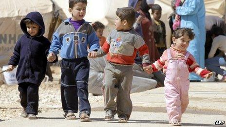 Syrian children walk amid tents at the Zaatari refugee camp, near the Syrian border with Jordan in Mafraq on 7 March 2013