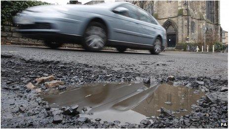 Car passing pothole