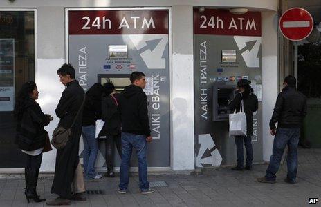 People queue outside a branch of Laiki Bank in Nicosia, Cyprus