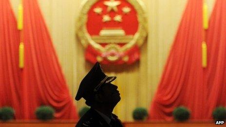 A member of the Chinese military band looks on before the closing session of the National People's Congress at the Great Hall of the People in Beijing, 17 March 2013