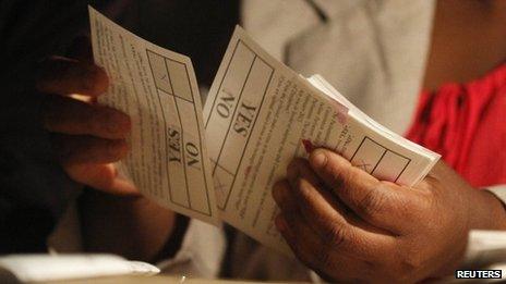 A Zimbabwean election official counts ballot papers after the close of voting on a referendum in Harare, 16 March 2013