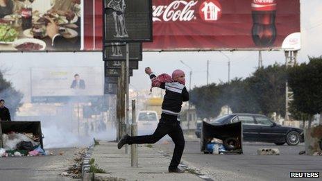 A Palestinian throws a stone at Israeli security forces during a protest in Nablus (18 February 2013)