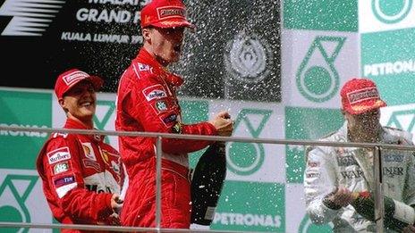 Michael Schumacher (left) celebrates with Eddie Irvine in Malaysia, 1999