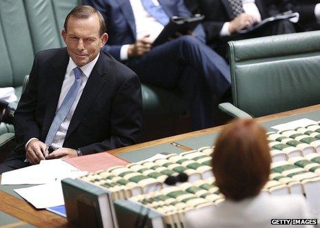 Oppostion leader Tony Abbott looks at Prime Minister Julia Gillard during House of Representatives question time