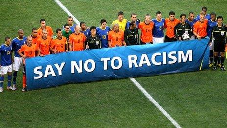 Footballers hold a 'Say No to Racism' banner