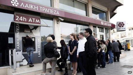 Queue at a cash machine outside a closed Laiki Bank branch in Nicosia