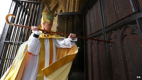 The Archbishop of Canterbury knocks to enter cathedral