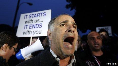 A protester shouts slogans during a rally by employees of Cyprus Popular Bank outside the parliament in Nicosia March 21, 2013