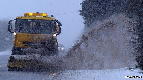 Gritter drives through slush puddle