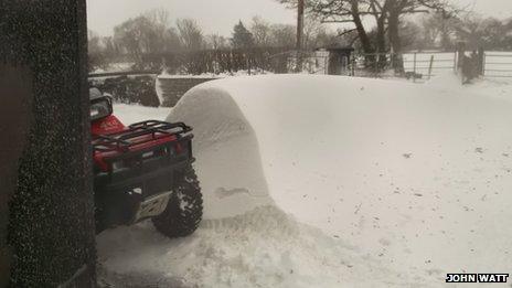 Snow drift beside quad bike