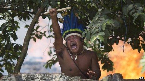 An indigenous man shouts at police as officers move in