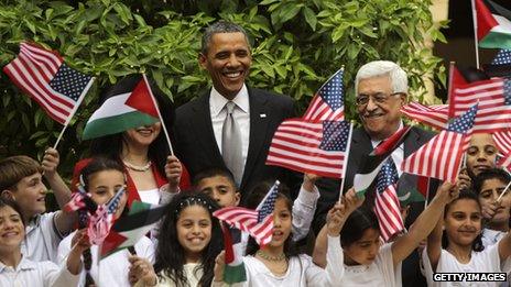 Barack Obama (C) poses Palestinian children during a visit to the Church of the Nativity with Palestinian President Mahmoud Abbas (R) in Bethlehem, West Bank, 22 March 2013