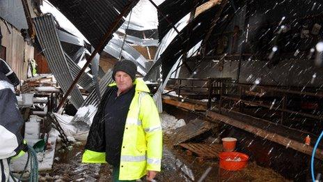 Farmer James McHenry surveys the damage caused to his sheds