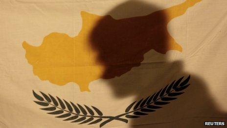 Protester casts a shadow onto a Cypriot flag in Nicosia on 24/3/13