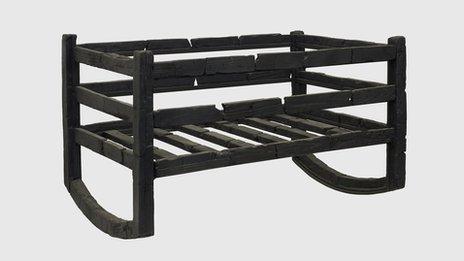 Carbonised wooden cradle. From the House of M.P.P.Granianus, Herculaneum, 1st century AD. Copyright Soprintendenza Speciale per i Beni Archeologici di Napoli e Pompei / Trustees of the British Museum