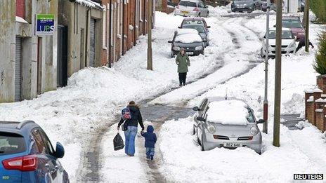 People walking on snowy road in N belfast