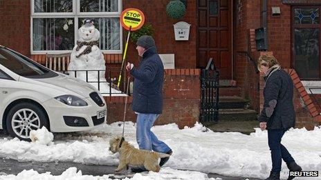 People walking on snowy road in N belfast