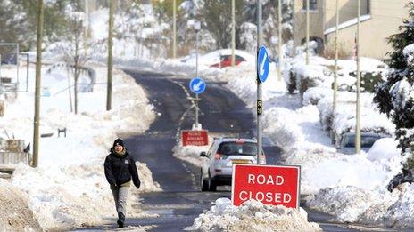 Man walks on closed road in Cargan in the Glens of Antrim