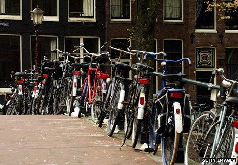 Bikes parked on a canal bridge in Amsterdam