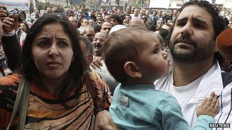 Alaa Abdel Fattah with wife and child outside prosecutor's office in Cairo. 26 March 2013