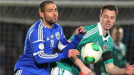 Itay Shechter of Italy in action against Northern Ireland defender Jonathan Evans