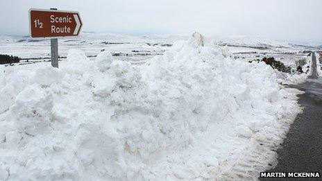 Snow piled around sign