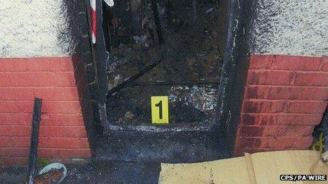 The charred front door at the house at Victory Road