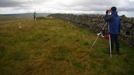 Amateur surveyors locating the summit of Thack Moor