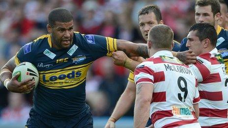 Leeds Ryan Bailey (left) is tackled by Jack Hughes and Michael McIlorum of Wigan