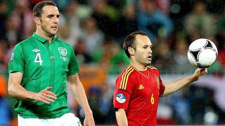 John O'Shea battles with Andres Iniesta during last year's game at Euro 2012