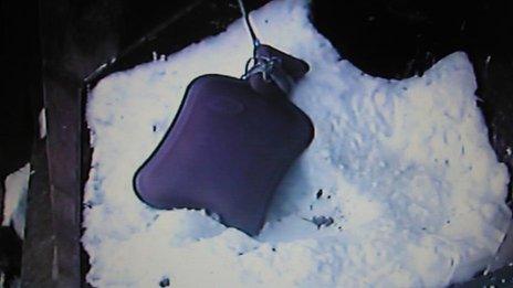 The hot water bottle lying in the snow.