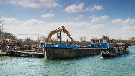 The boat delivers materials to the building site