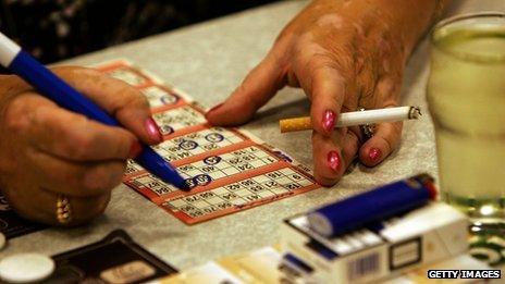 Woman smoking while marking her bingo card